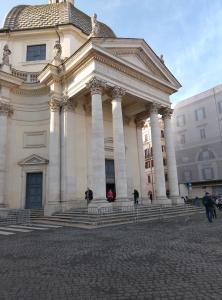 a large building with people walking in front of it at Vista sul Corso rooms in Rome