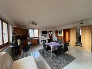 a living room and kitchen with a table and chairs at Dom pri kúpalisku Thermalpark na Malotejedskej in Dunajská Streda +22 photos