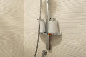 een badkamer met twee zeepdispensers aan de muur bij Sabbie dell'Etna - Eleganza e Comfort nel Cuore di Catania con Parcheggio Privato in Catania +43 foto's