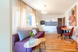 a living room with a couch and a table at Apartments Casa Barbara in Rab