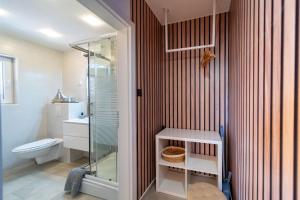 a bathroom with a toilet and a glass shower at Apartments Casa Barbara in Rab +70 photos