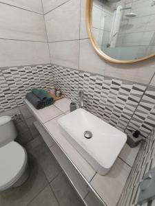 a bathroom with a white sink and a mirror at studio cosy idéalement situé parking privé in Ajaccio
