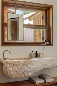 a bathroom with a stone sink and a mirror at Ahama - Relais & Châteaux in Fethiye +56 photos