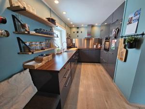 a large kitchen with a wooden counter top at Flott beliggenhet svært sentralt i sentrum in Svolvær