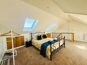 a bedroom with a bed in a attic at Stunning 2 bedroom flat for 5 people overlooking the sea 2A in Felixstowe +71 photos