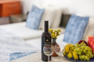 a bottle of wine and two glasses on a table at Marylee's studio Old town Rethymno standard studio Adults Only in Rethymno