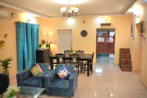a living room with a table and chairs and a dining room at 2nd Innings Calangute Private in Calangute