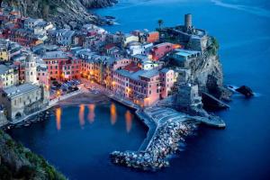 an aerial view of a town in the water at night at La Randa apartment in Vernazza