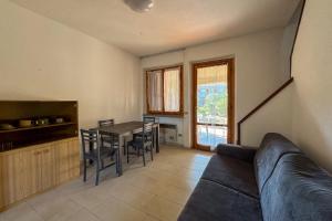 a living room with a couch and a table at Appartamento Manta civico 4 in Principina a Mare