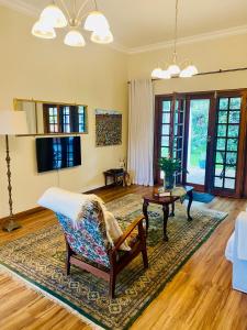 a living room with a couch and a table at Rondeletia Cottage Guesthouse - premium self catering in Winston Park +34 photos