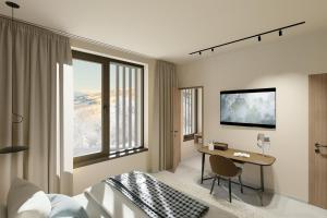 a bedroom with a bed and a desk and a window at Appartement Chalet Saalbach in Saalbach Hinterglemm