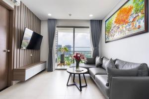 a living room with a couch and a table at Swimming Pool 35th Floor District 7 in Ho Chi Minh City