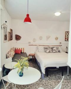 a bedroom with a bed and a table and a couch at Casalago in Domaso