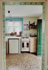 a kitchen with a white stove and a green door at Casalago in Domaso +88 photos