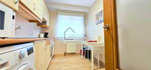 a small kitchen with a sink and a table at La Gran Manzana de Villaviciosa in Villaviciosa +21 photos