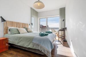 a bedroom with a bed and a large window at FozPenthouse in Foz do Arelho +36 photos
