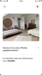 a screenshot of a bedroom with a bed in a room at Chez Virginie in Floing