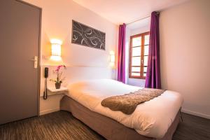 a bedroom with a bed with purple curtains and a window at Théâtre Hôtel Chambéry in Chambéry