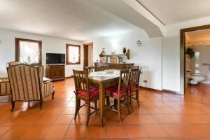 a kitchen and dining room with a table and chairs at Comfortable house - garden and parking in Farra di Soligo