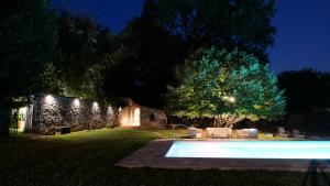 a swimming pool in a yard at night at Case Bernardini Suites in Ghivizzano