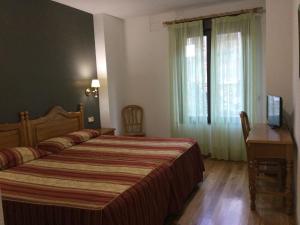 Posteľ alebo postele v izbe v ubytovaní Hotel Cinco Castaños