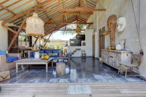 un ampio soggiorno con tavolo e sedie di Beautiful Rustic 3bd Villa in Bingin a Uluwatu