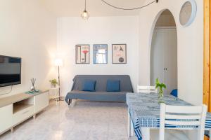 a living room with a blue couch and a tv at La palazzina al LINGOTTO in Turin