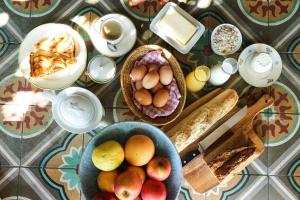 a table topped with bowls of eggs and bread at Le Presbytère de Bugarach in Bugarach +27 photos