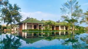 a house with its reflection in the water at Famiana Green Villa in Phu Quoc