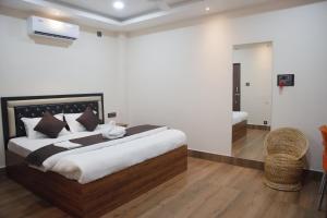 a bedroom with a large bed and a mirror at D9 Restaurant and Hotel in Khetri
