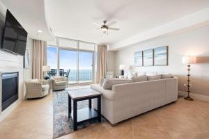 a living room with a couch and a tv at Turquoise D1306 in Orange Beach