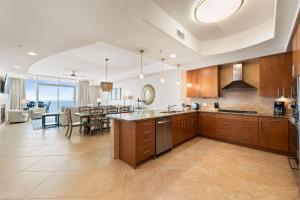 an open kitchen with a dining room and a dining table at Turquoise D1306 in Orange Beach