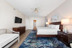 a bedroom with two beds and a flat screen tv at Turquoise D1306 in Orange Beach +43 photos