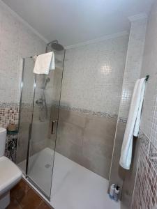 a shower with a glass door in a bathroom at Alojamiento Rural Ikigai in Losa del Obispo +23 photos