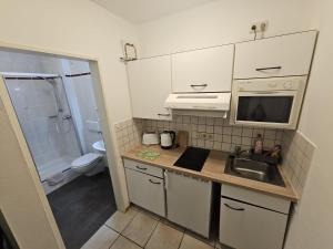 Kuchyň nebo kuchyňský kout v ubytování Apartmenthaus Home24