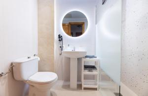 a bathroom with a toilet and a sink and a mirror at LAS COLUMNAS in Port de Pollensa