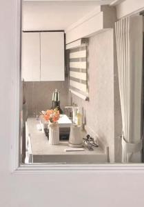 a kitchen with a sink and a counter with flowers at Namsan Nest in Seoul