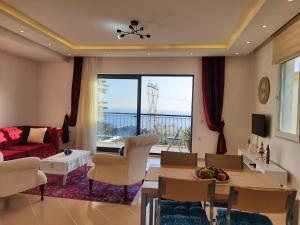 a living room with a red couch and a table at Glennhouse in Kaş