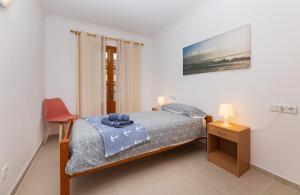 a bedroom with a bed and a table and a chair at LAS COLUMNAS in Port de Pollensa