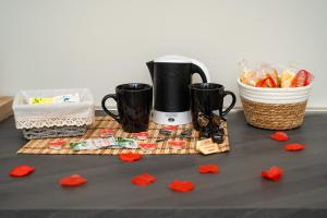 a coffee maker on a table with red paper hearts at B&B La Camelia Luxury Suite in Terlizzi