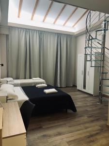 Postel nebo postele na pokoji v ubytování Il Galileo Rooms