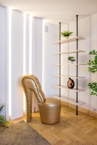 a high heel chair in a living room with a shelf at Apartament w centrum - duplex penthouse in the centre with terrace and air conditioning in Krakow