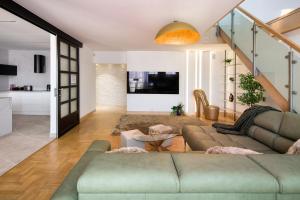 a living room with a couch and a table at Apartament w centrum - duplex penthouse in the centre with terrace and air conditioning in Krakow