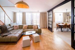 a living room with a couch and a table at Apartament w centrum - duplex penthouse in the centre with terrace and air conditioning in Krakow +43 photos