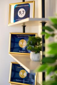 two shelves with blue and gold boxes with a potted plant at Apartament w centrum - duplex penthouse in the centre with terrace and air conditioning in Krakow
