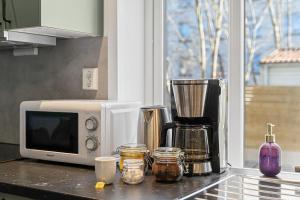 a kitchen counter with a microwave and other items on it at Nord Apartments in Trondheim