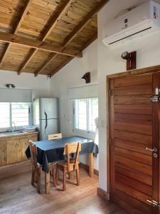 a kitchen and dining room with a table and chairs at Casita Amarilla in Miramar