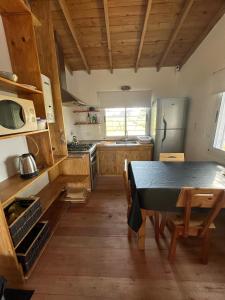 a kitchen with a table and a kitchen with a refrigerator at Casita Amarilla in Miramar