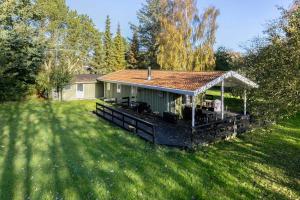 a house with a deck in a yard at Unobstructed Summer House In Lovely Langeland in Tranekær