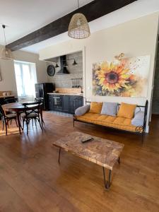 a living room with a couch and a table at Domaine de Sens Bas in Molières
